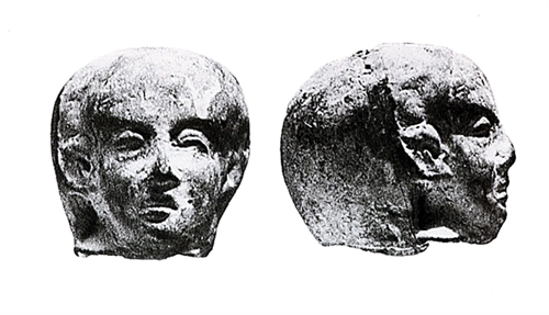 Head from terracotta with features of the Ancient Egyptian statue